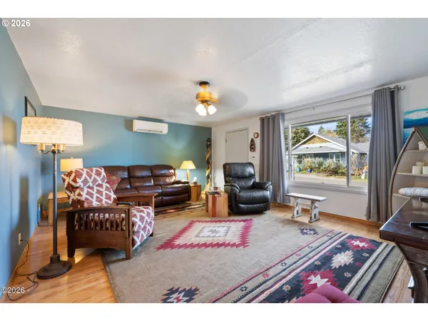 a living room with furniture a rug and a flat screen tv