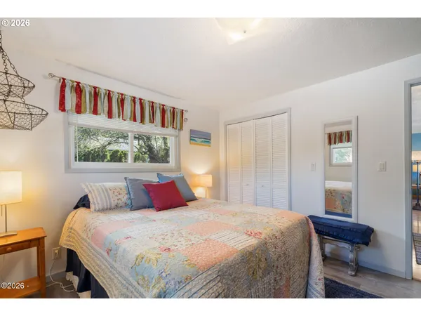 a bedroom with a large bed and a window