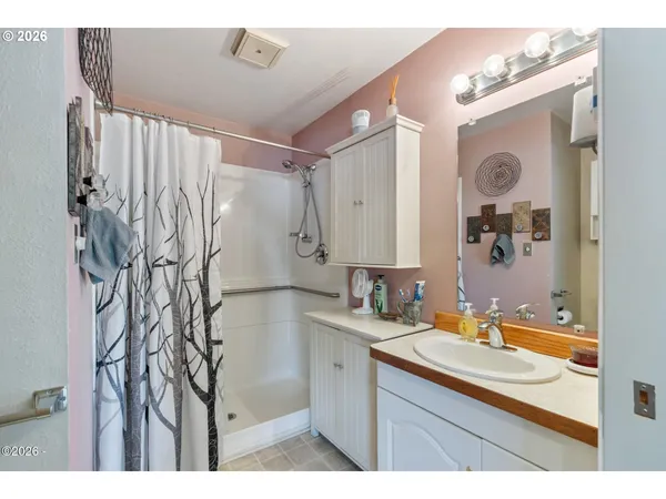 a bathroom with a bathtub sink and mirror