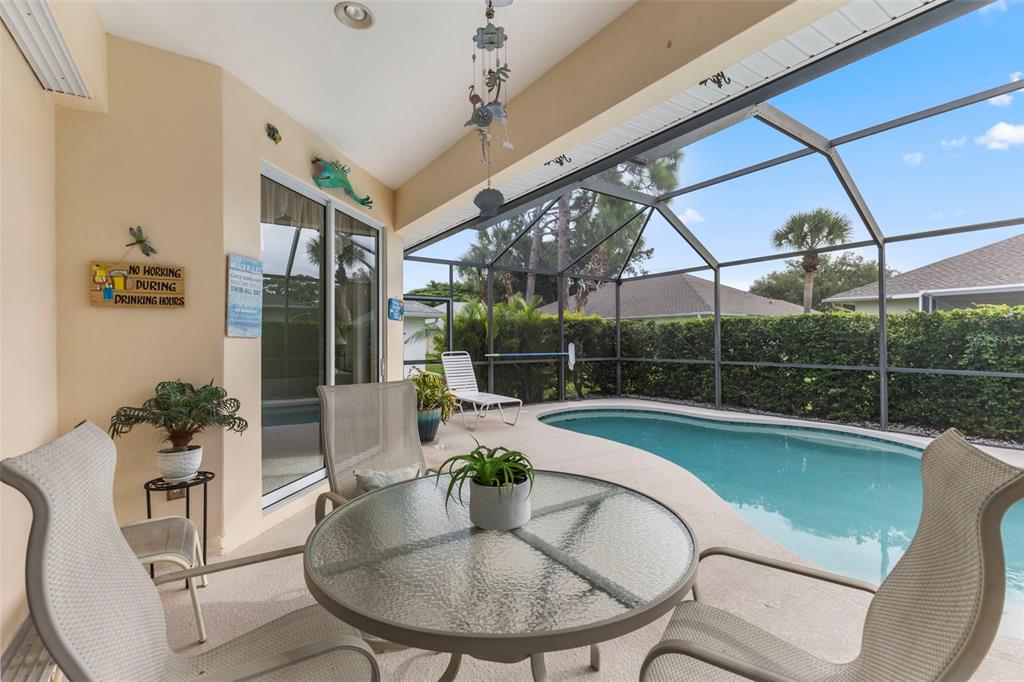 5823 McKinley Road Venice, FL 34293 - Photo 14 of 44 a view of a dining room with furniture wooden floor and a chandelier