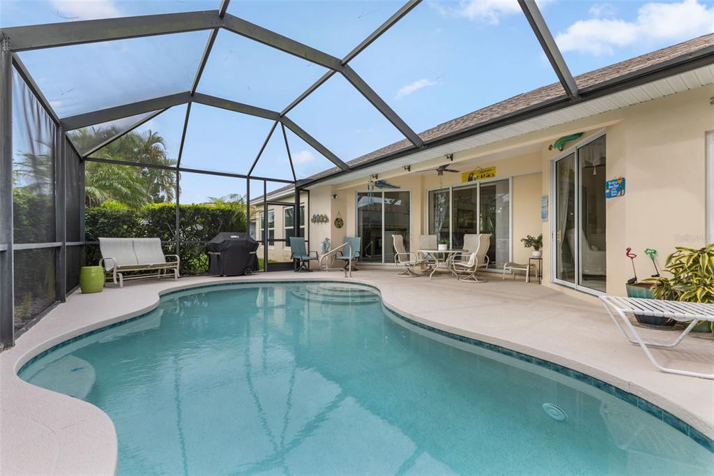 5823 McKinley Road Venice, FL 34293 - Photo 16 of 44 a view of a patio with swimming pool table and chairs