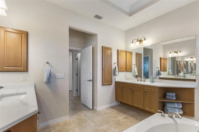 a kitchen with a sink and chairs