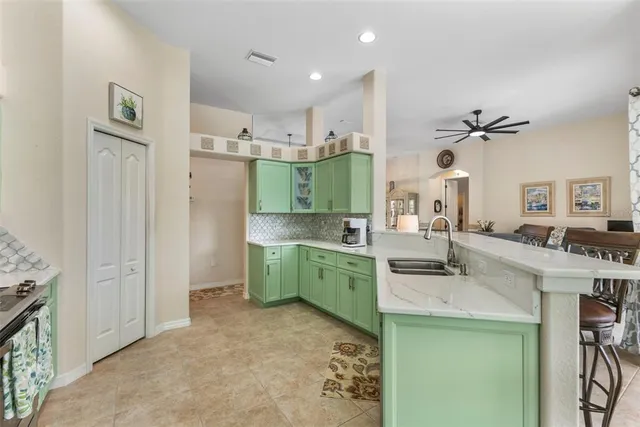 a kitchen with a sink dishwasher a stove and a refrigerator with wooden floor