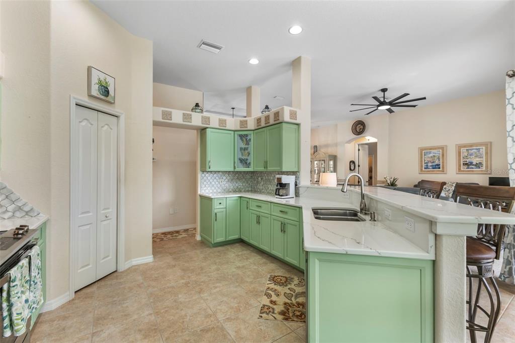 5823 McKinley Road Venice, FL 34293 - Photo 29 of 44 a kitchen with a sink dishwasher a stove and a refrigerator with wooden floor