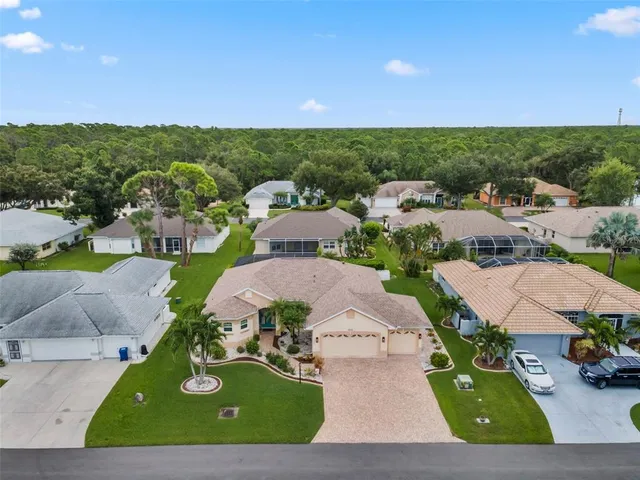 an aerial view of residential houses with outdoor space and street view