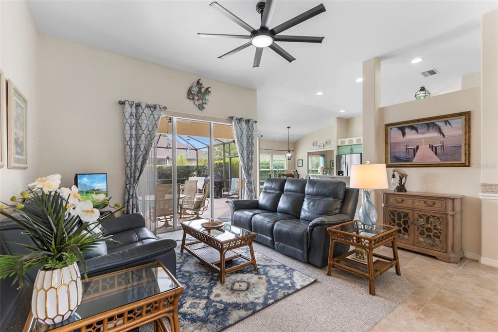 5823 McKinley Road Venice, FL 34293 - Photo 34 of 44 a living room with furniture ceiling fan and a large window
