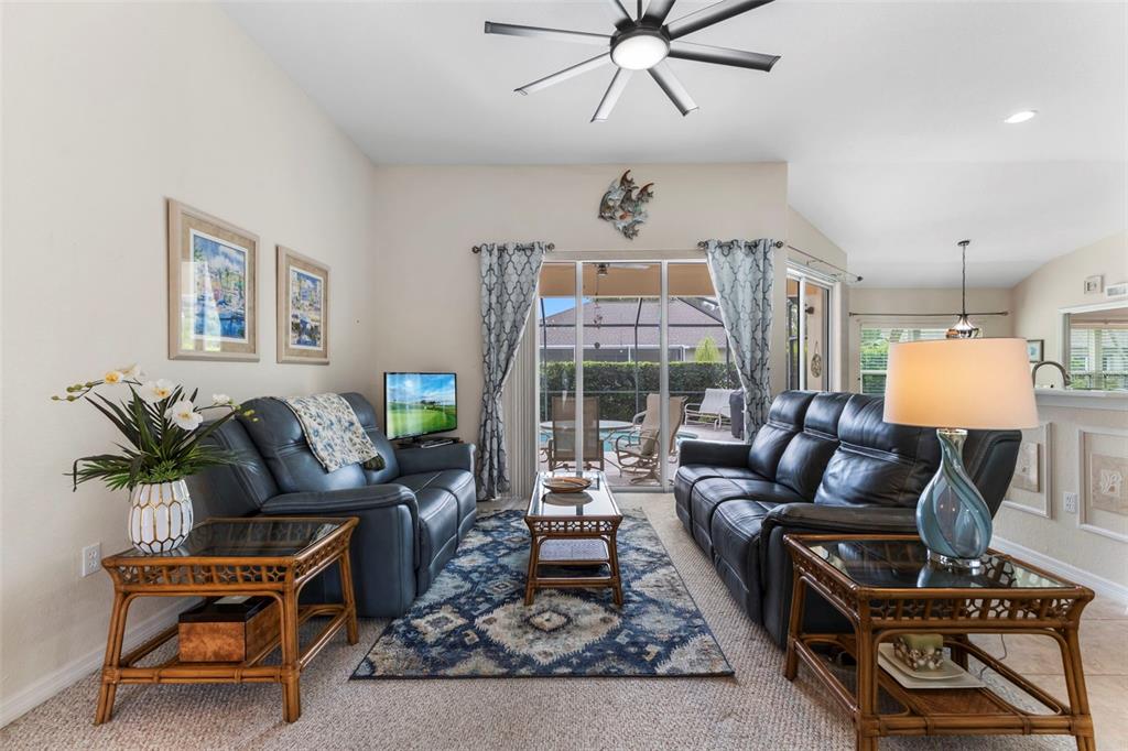 5823 McKinley Road Venice, FL 34293 - Photo 35 of 44 a living room with furniture a fireplace and a chandelier