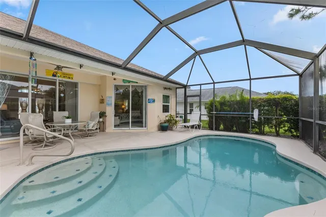 a view of a patio with swimming pool table and chairs