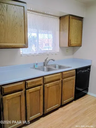 a kitchen with stainless steel appliances granite countertop a sink dishwasher a cabinets and wooden floor