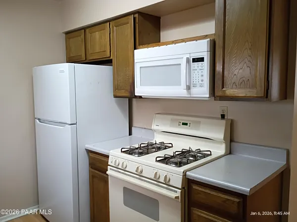 a kitchen with a stove and a refrigerator