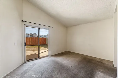 an empty room with sliding glass door