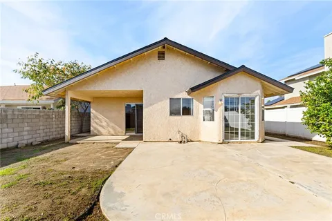 a view of a house with wooden fence