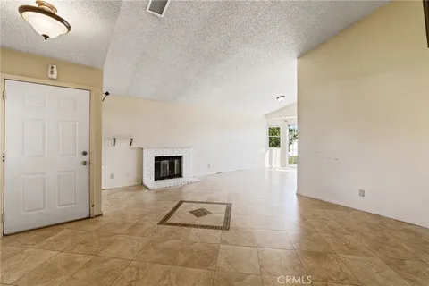 a view of a hallway with wooden floor and a fireplace