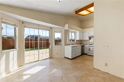 a large white kitchen with a sink and cabinets