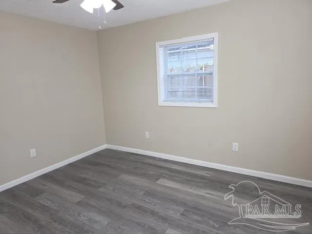 an empty room with wooden floor and closet