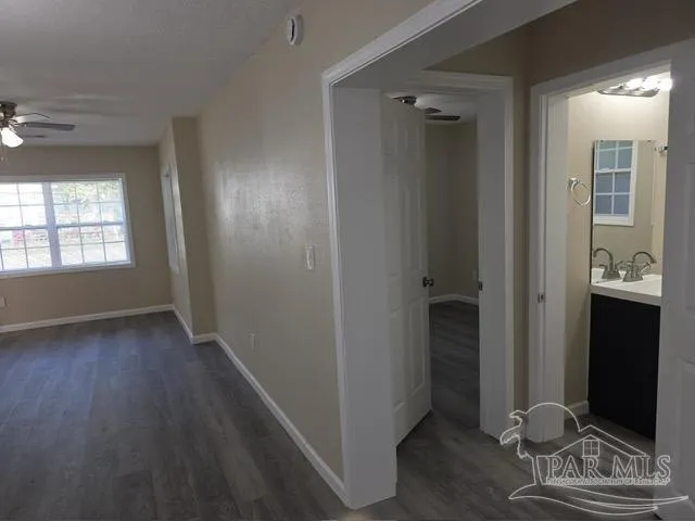 a view of a hallway with wooden floor