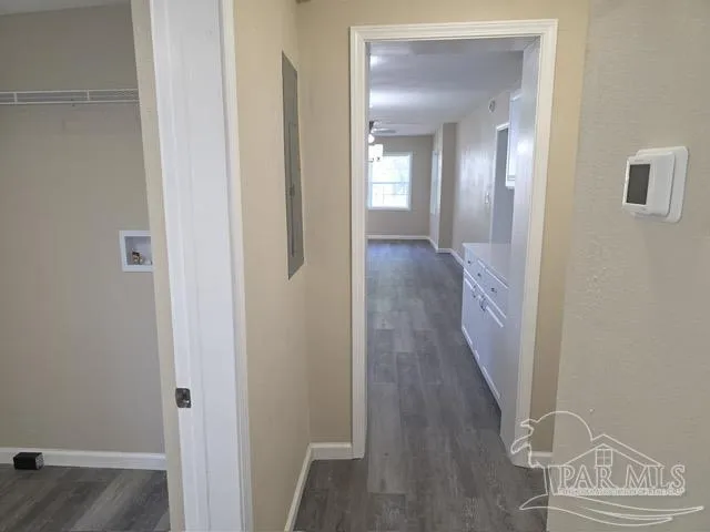 an empty room with wooden floor and closet