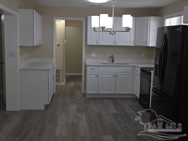 4001 Harrison Avenue Jay, FL 32565 - Photo 5 of 20 a kitchen with stainless steel appliances granite countertop a sink stove and refrigerator