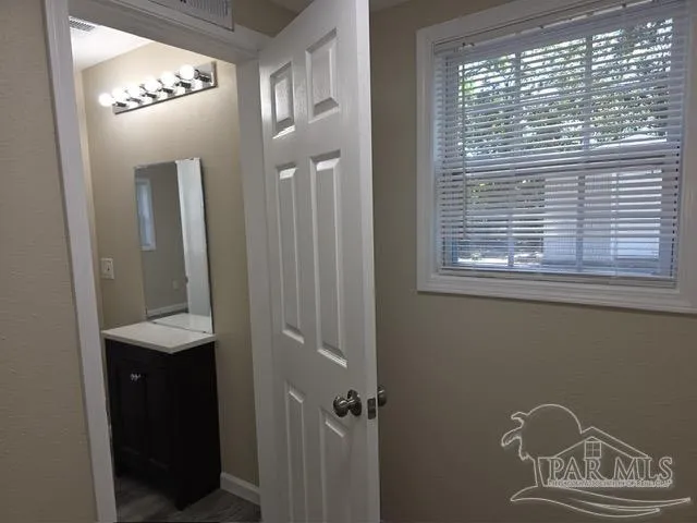 a view of a hallway with windows