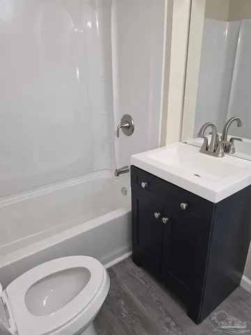 a bathroom with a sink a toilet and bathtub