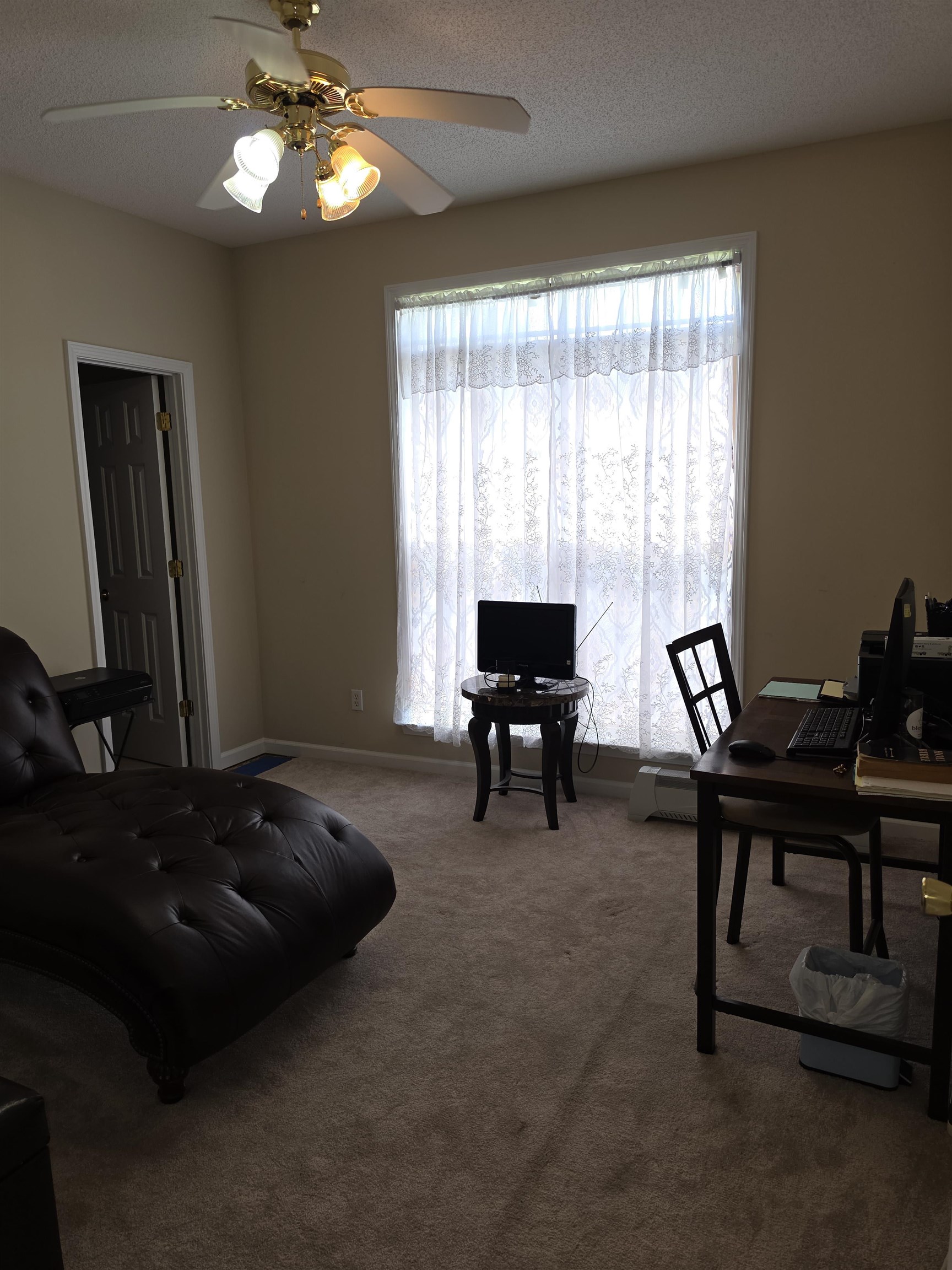 7253 Rourke Circle Memphis, TN 38125 - Photo 12 of 31 Room featuring neutral-toned carpet, a ceiling fan with integrated lighting, and a large window