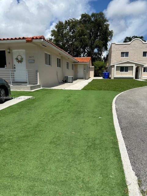 3677 Southwest 14th Street Miami, FL 33145 - Photo 2 of 12 a front view of house with yard