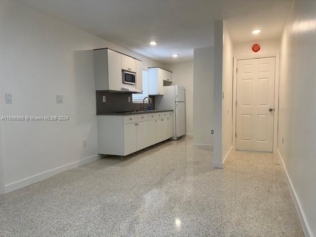 3677 Southwest 14th Street Miami, FL 33145 - Photo 3 of 12 a room with furniture and a flat screen tv