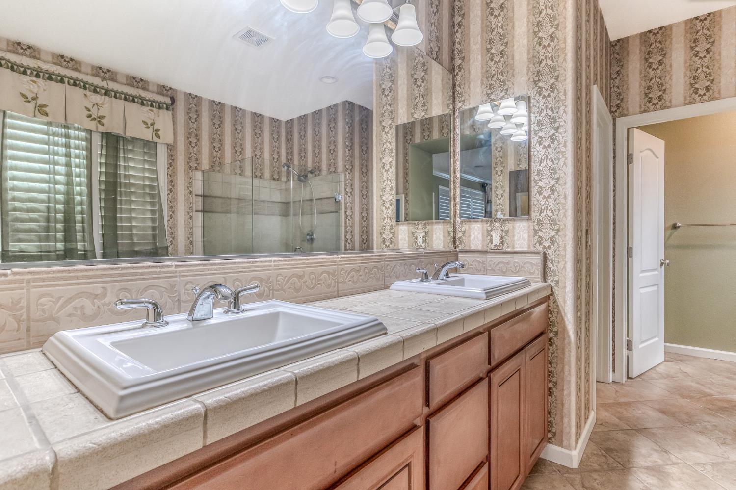 188 Thomsen Road Lathrop, CA 95330 - Photo 24 of 27 a bathroom with a sink double vanity and a mirror