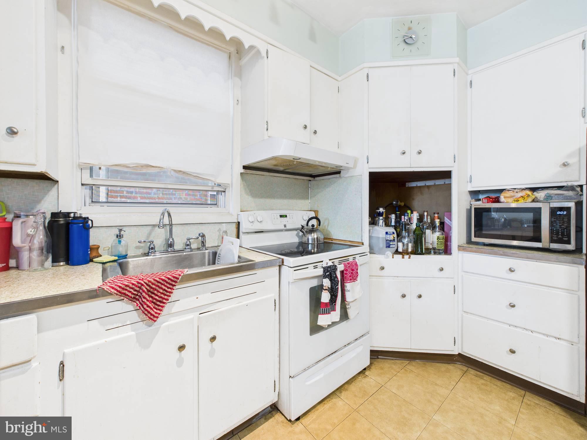 4073 West Ford Road Philadelphia, PA 19131 - Photo 15 of 50 a kitchen with white cabinets and white appliances