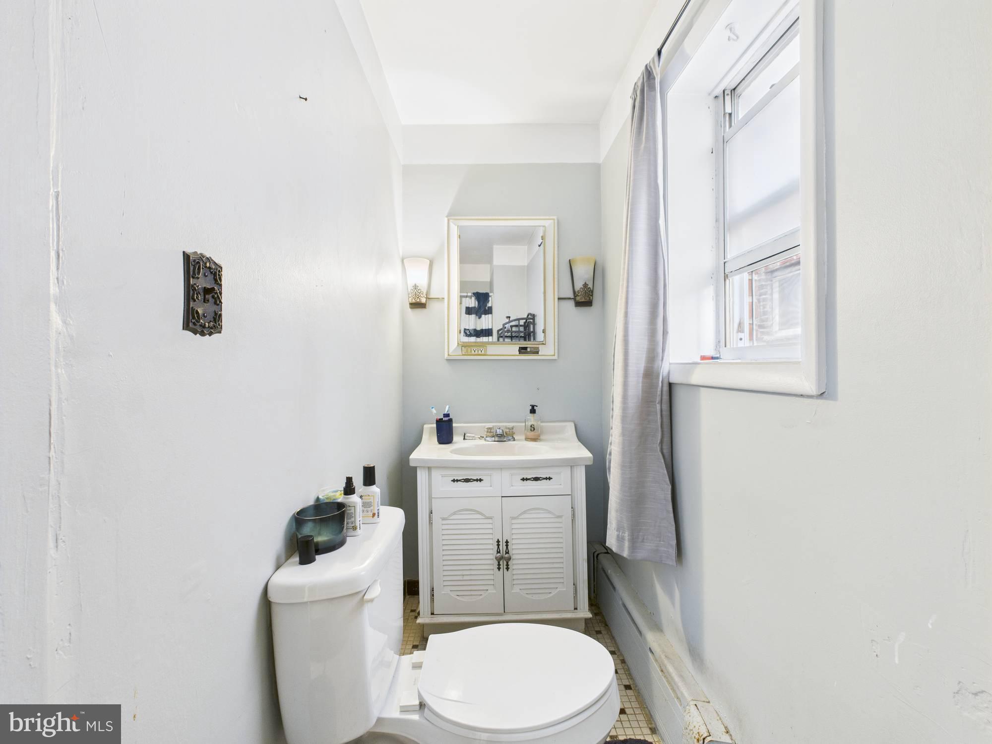 4073 West Ford Road Philadelphia, PA 19131 - Photo 23 of 50 a white toilet sitting next to a bathroom sink