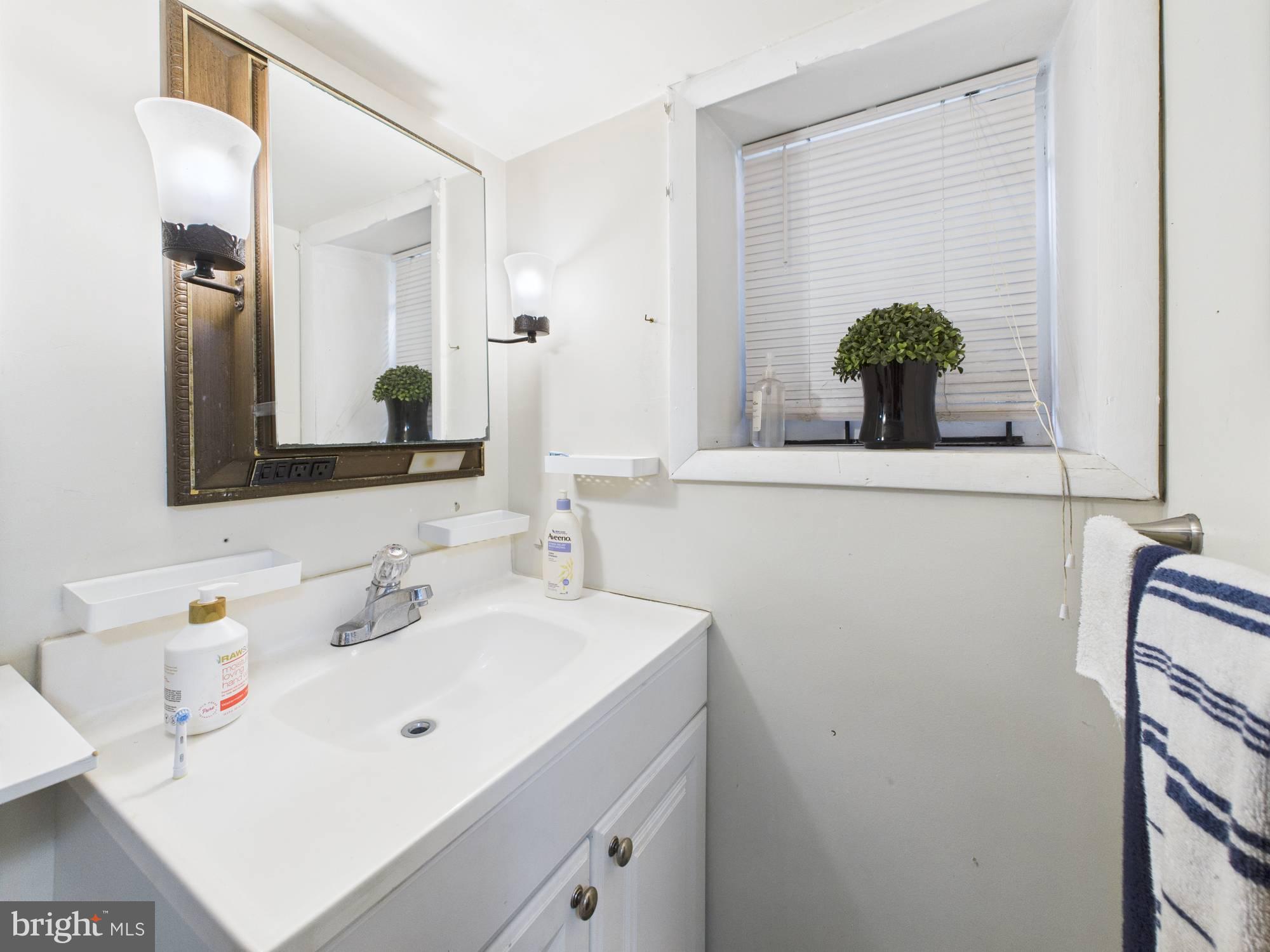 4073 West Ford Road Philadelphia, PA 19131 - Photo 32 of 50 a bathroom with a sink and a mirror