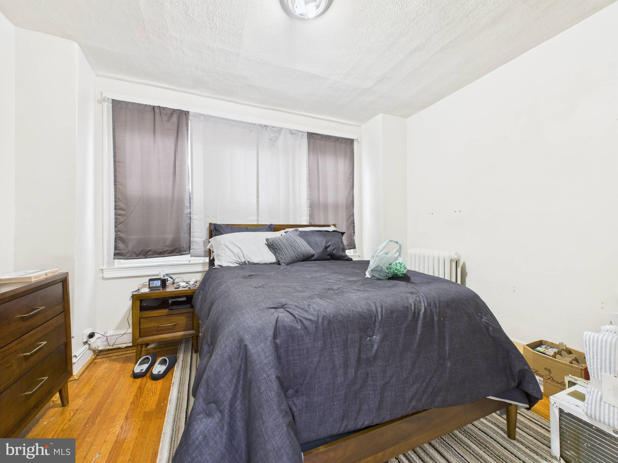 4073 West Ford Road Philadelphia, PA 19131 - Photo 36 of 50 a bed sitting in a bedroom next to a window and dresser