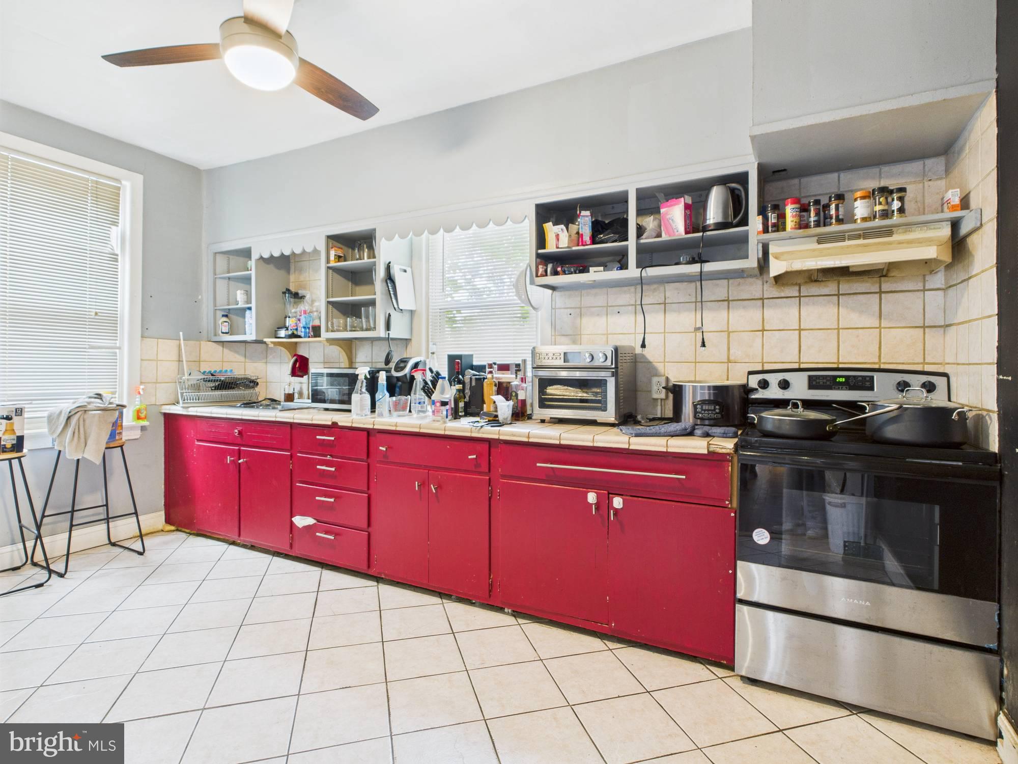 4073 West Ford Road Philadelphia, PA 19131 - Photo 40 of 50 a kitchen with stainless steel appliances granite countertop a stove a sink and a microwave