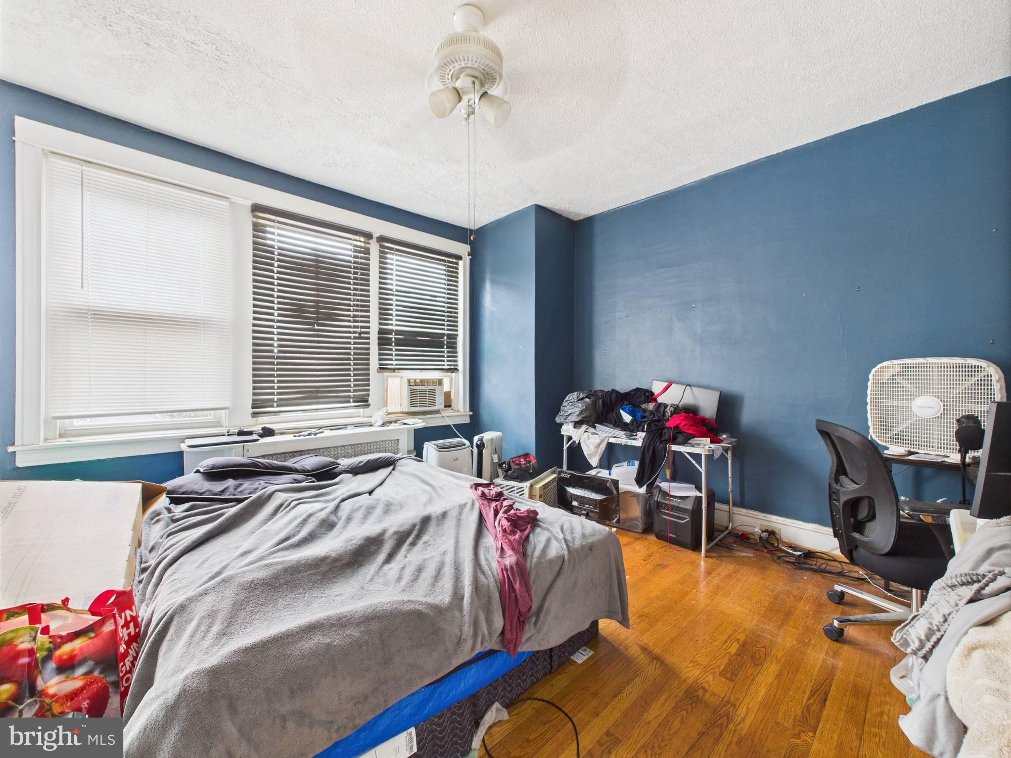 4073 West Ford Road Philadelphia, PA 19131 - Photo 49 of 50 a bed sitting in a bedroom next to a window