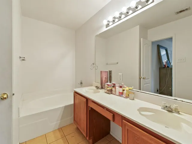 a bathroom with a toilet sink vanity and mirror