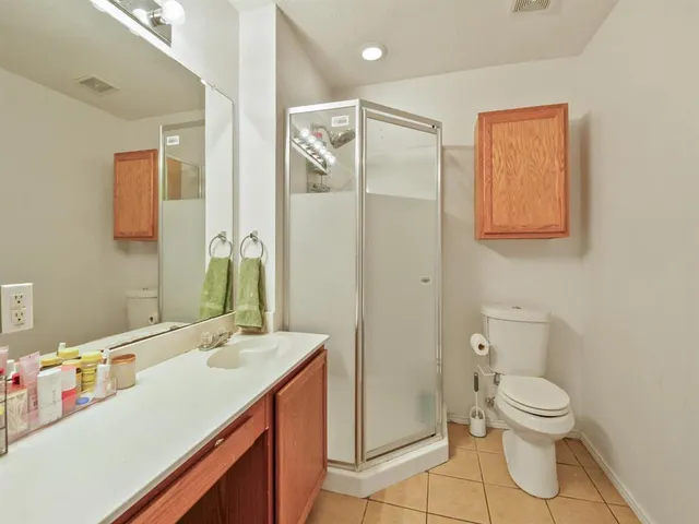 a white toilet sitting next to a bathroom sink