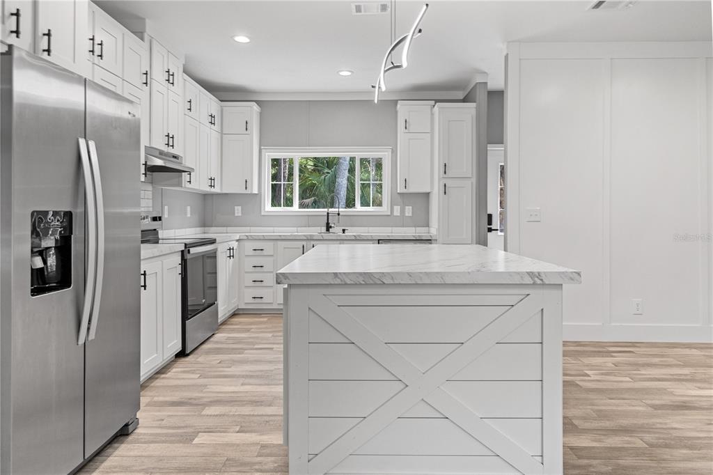 375 Sapp Street Inglis, FL 34449 - Photo 10 of 36 a kitchen with stainless steel appliances a sink stove and refrigerator