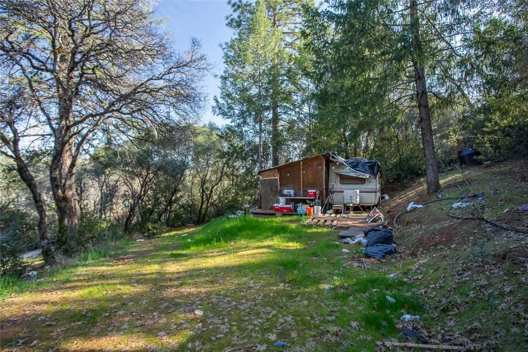 0 Condor Road Oroville, CA 95965 - Photo 22 of 29 a view of a backyard with table and chairs a barbeque and a large trees