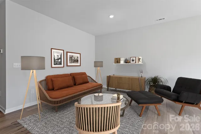 a living room with furniture and a lamp