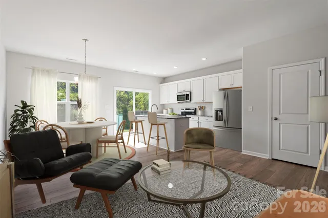 a living room with furniture and kitchen view
