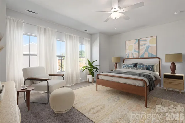 a spacious bedroom with a bed and a chandelier