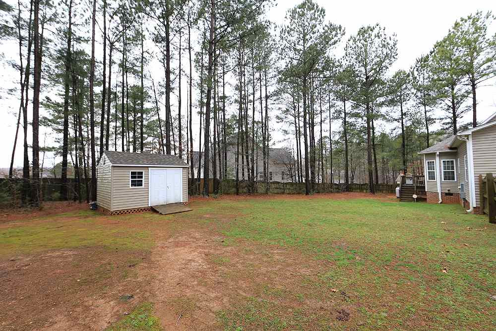 5904 Shedd Drive Raleigh, NC 27603 - Photo 23 of 25 Storage shed in the back yard is ideal for storing lawn equipment. Back Yard
