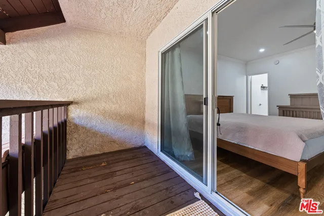 a room with wooden floor and staircase