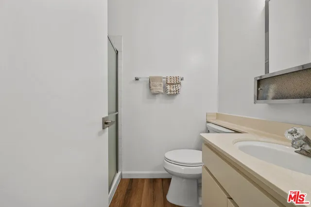 a white toilet sitting next to a bathroom sink