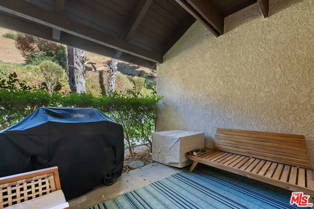 a view of a bench in back yard of a house
