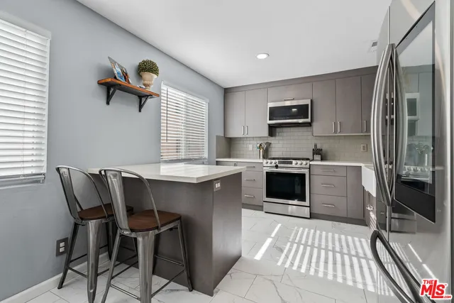 a kitchen with a stove a sink and a refrigerator