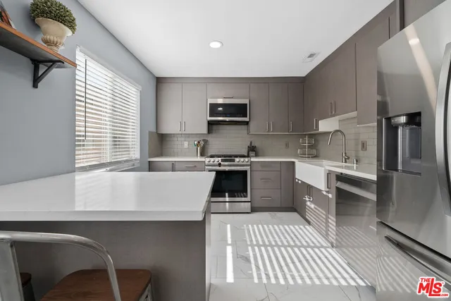 a kitchen with a sink cabinets and stainless steel appliances