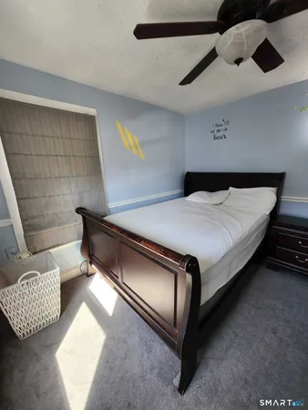 a bed sitting in a room next to a window