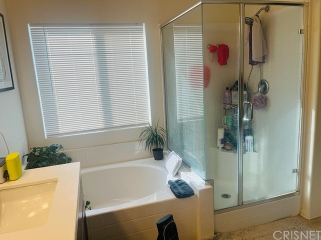 610 West Woodcrest Street Rialto, CA 92376 - Photo 15 of 33 a bathroom with a tub a sink and a shower