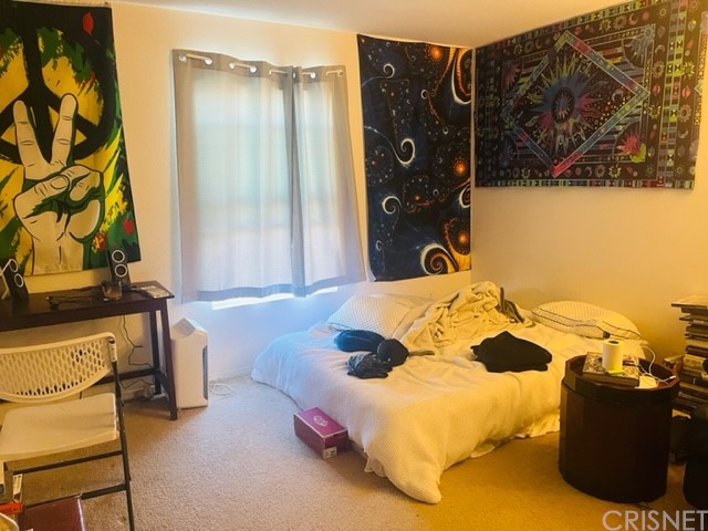 610 West Woodcrest Street Rialto, CA 92376 - Photo 21 of 33 a bedroom with a bed and wooden floor